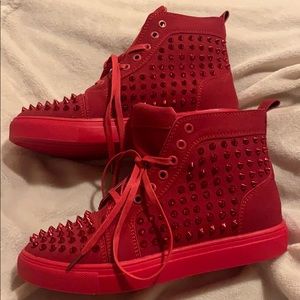 Red spiked high top sneaker